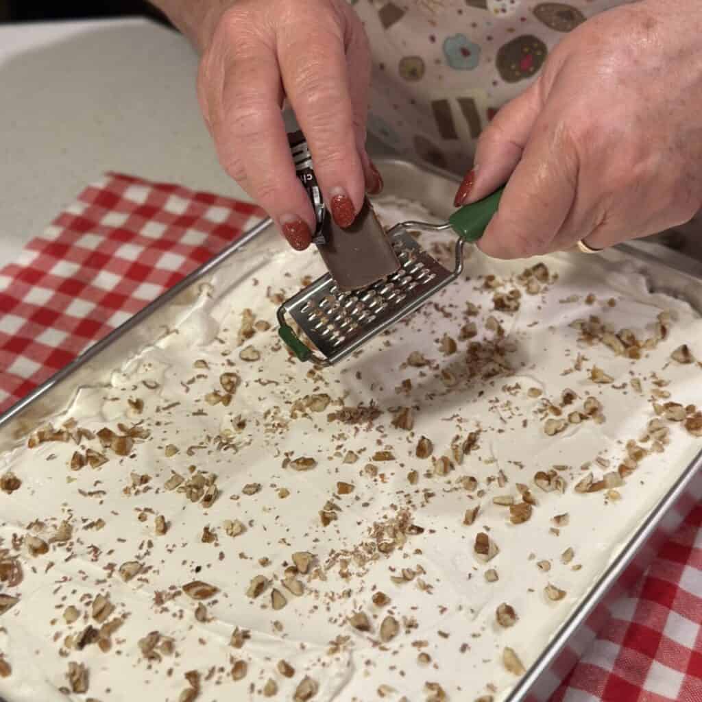 Grating chocolate on a dessert.