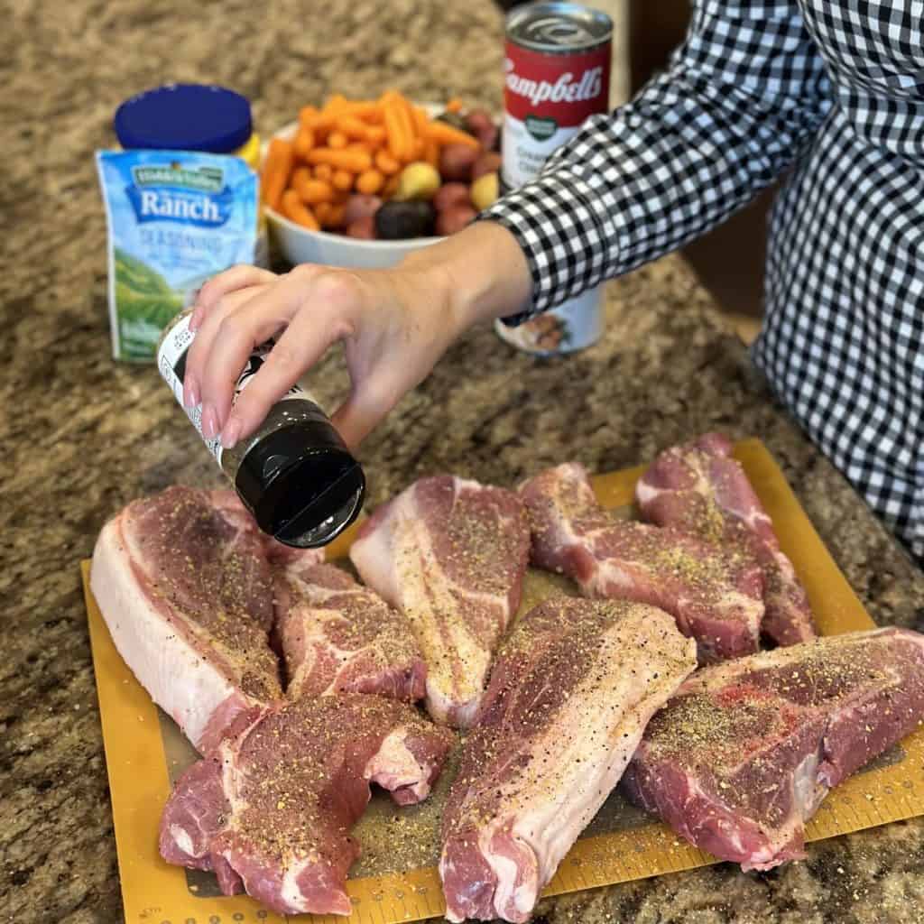 Sprinkling seasoning on ribs.