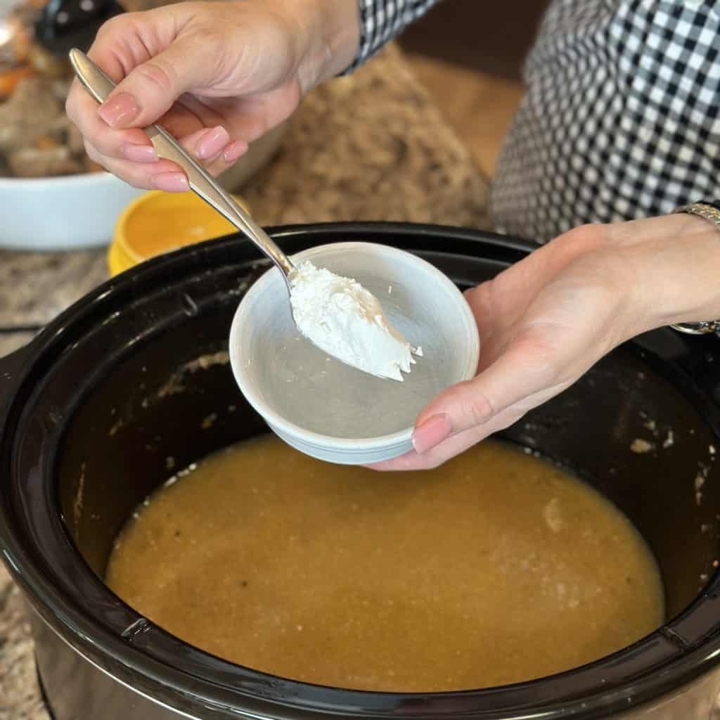 Whisking together water and cornstarch for a slurry.