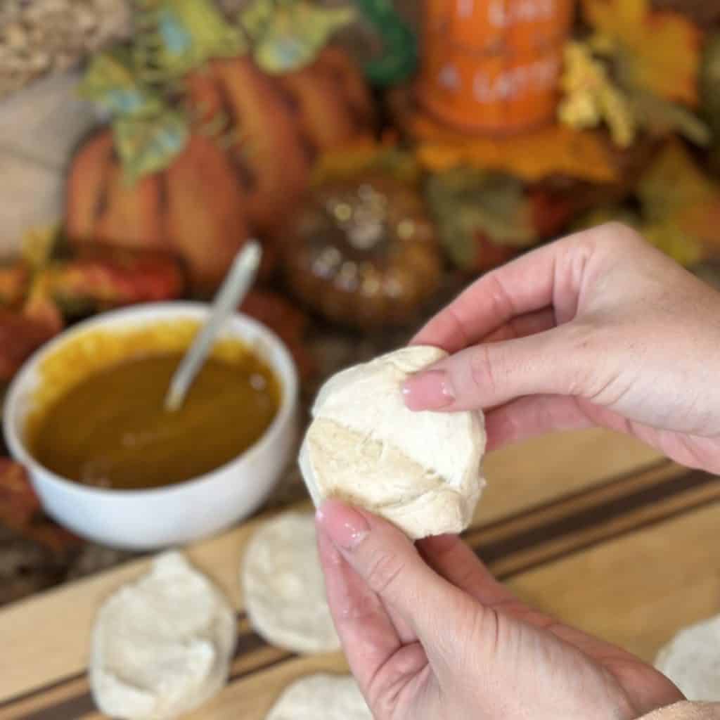 Peeling apart the layers of biscuit dough.