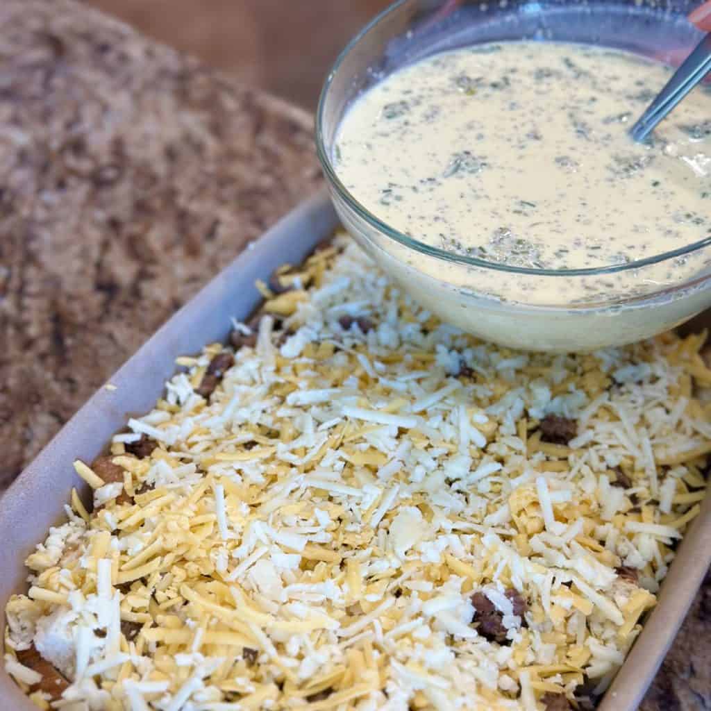 Pouring custard on a casserole to be baked.