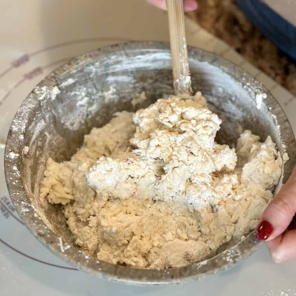 Stirring biscuit dough in a bowl.