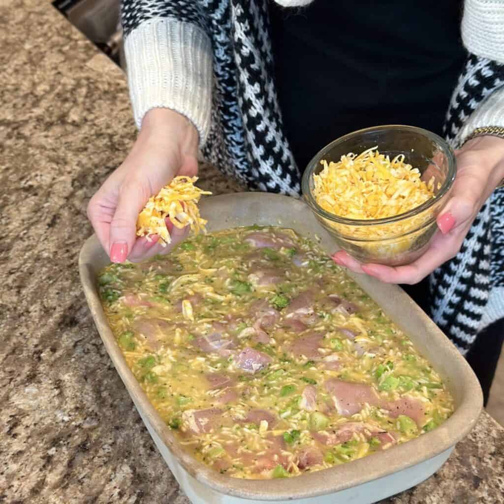 Adding cheese to the top of a casserole.