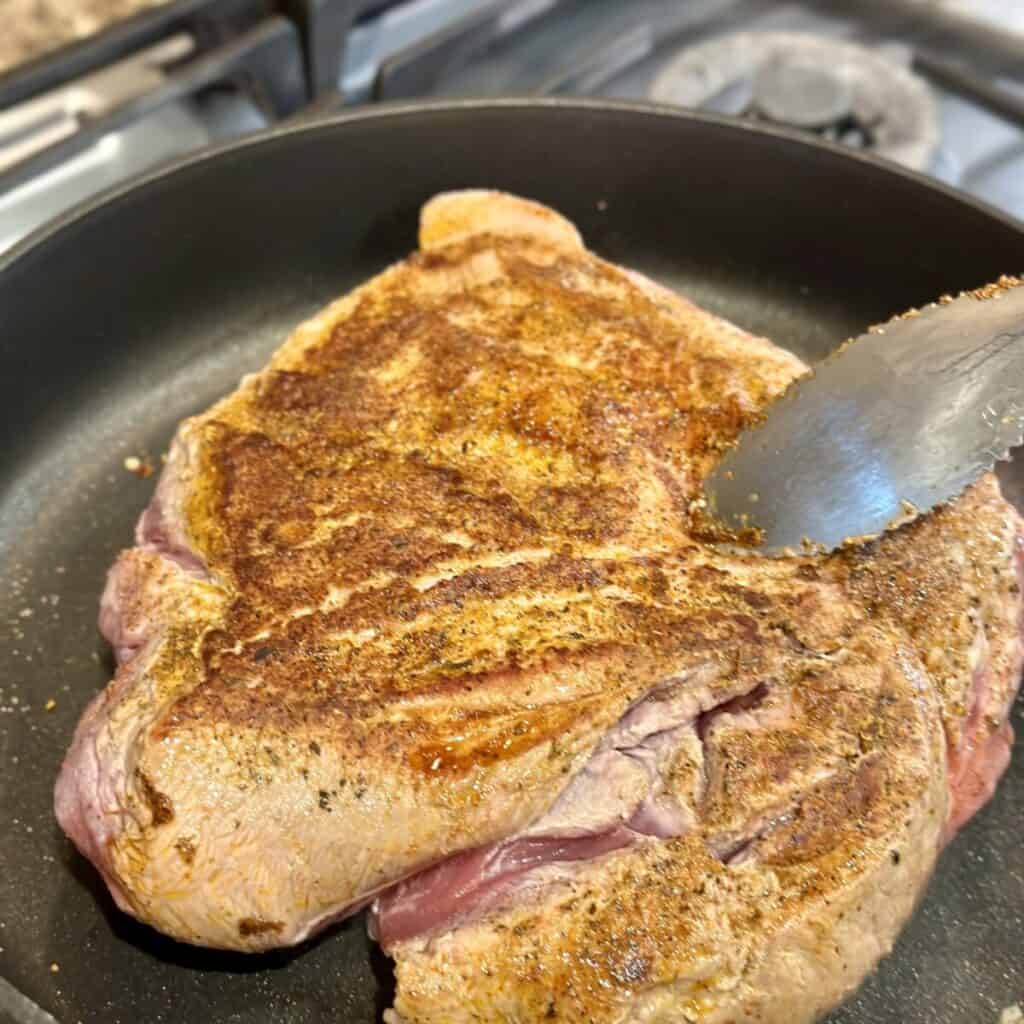 Searing a pork roast.