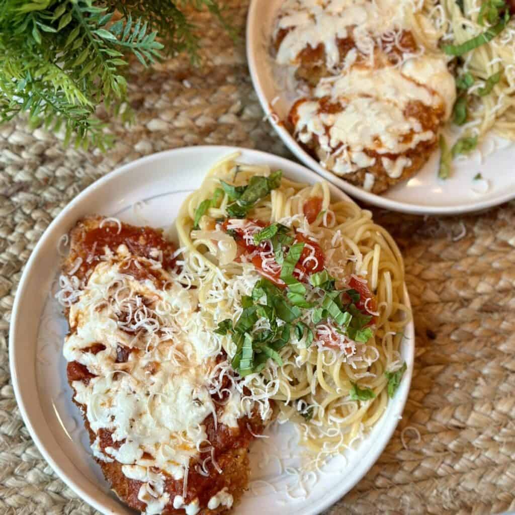 A plate of chicken parmesan and pasta.