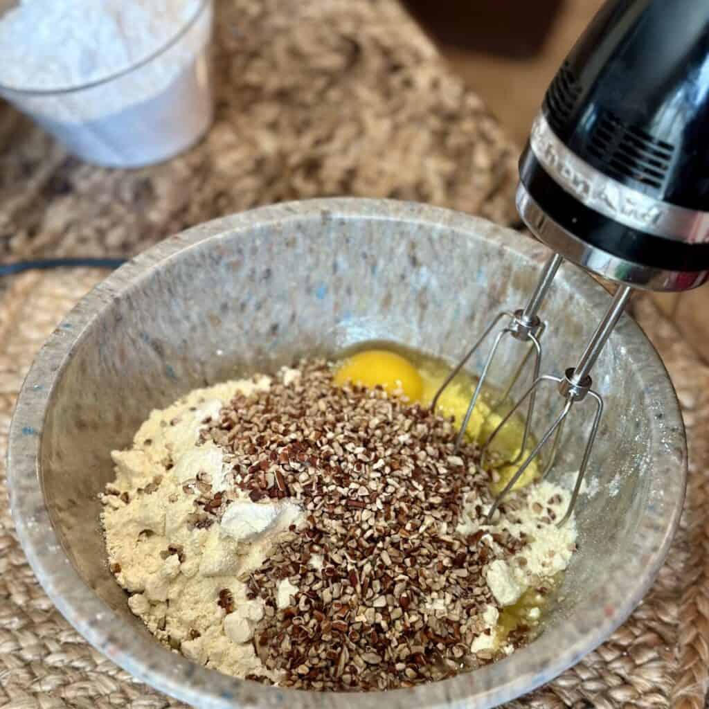 The ingredients in a bowl to make the crust for yum yum bars.