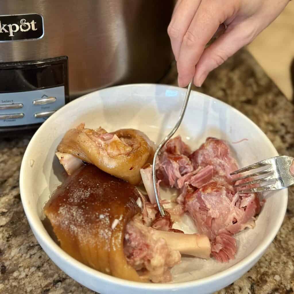 Shredding a pork shank.