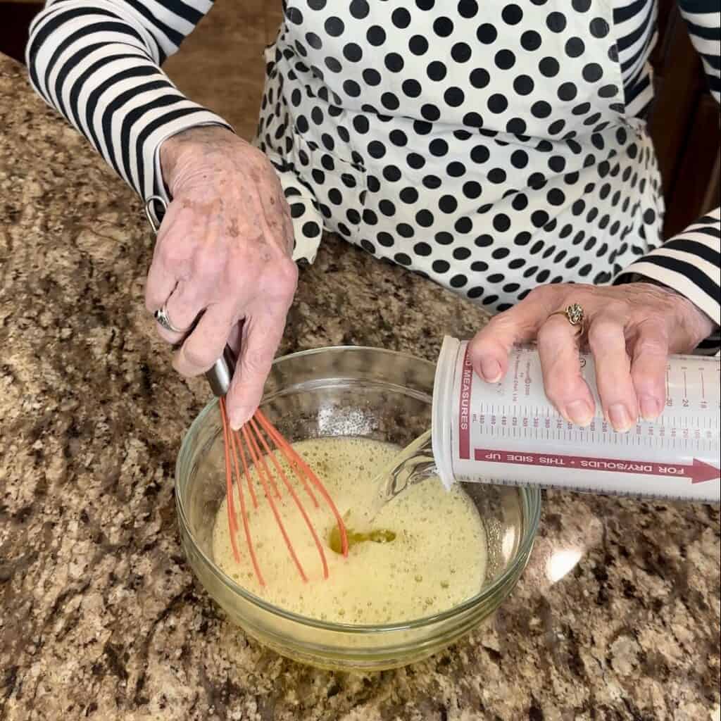 Mixing together lemon jello and water.