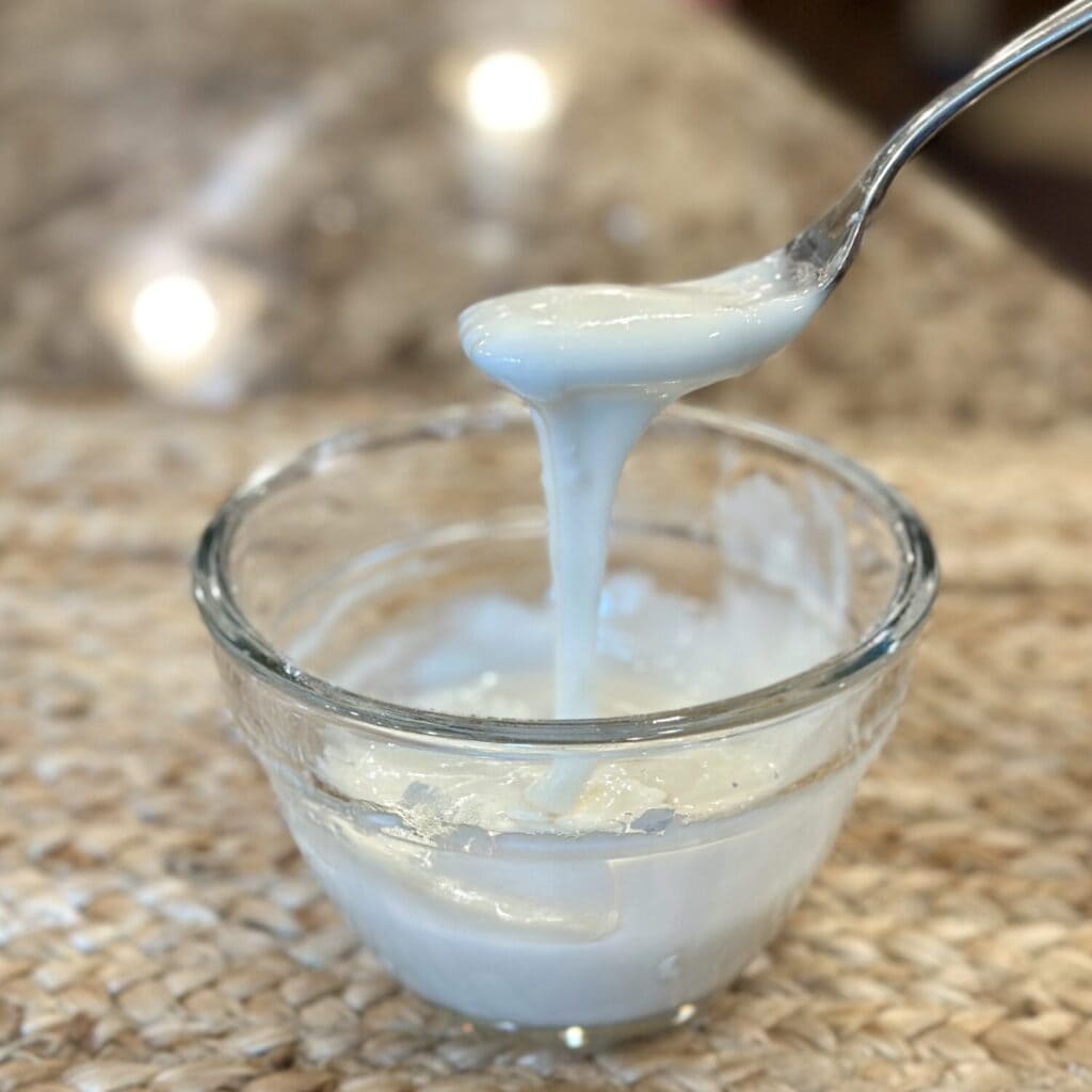 Mixing icing for the top of biscuits.