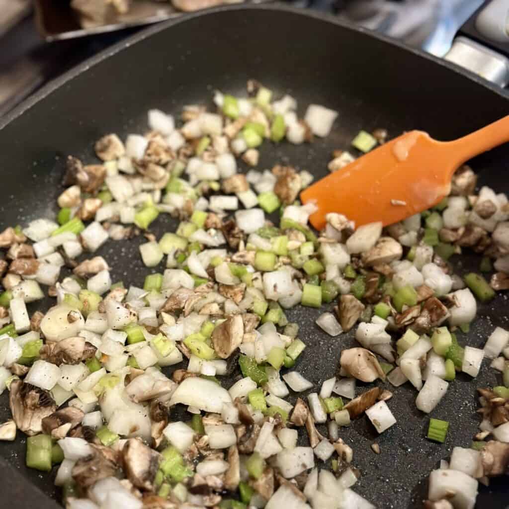 Sautéing vegetables in a skillet.