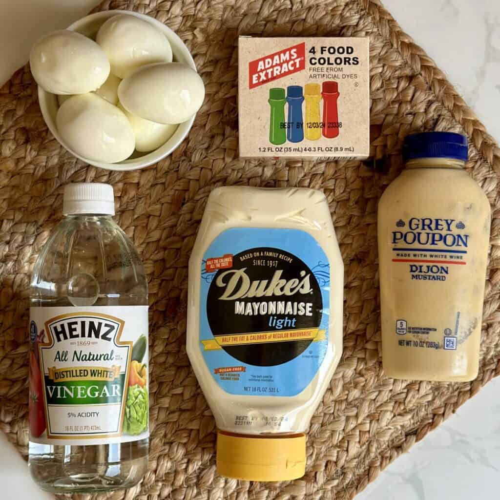 The ingredients to make colored deviled eggs.