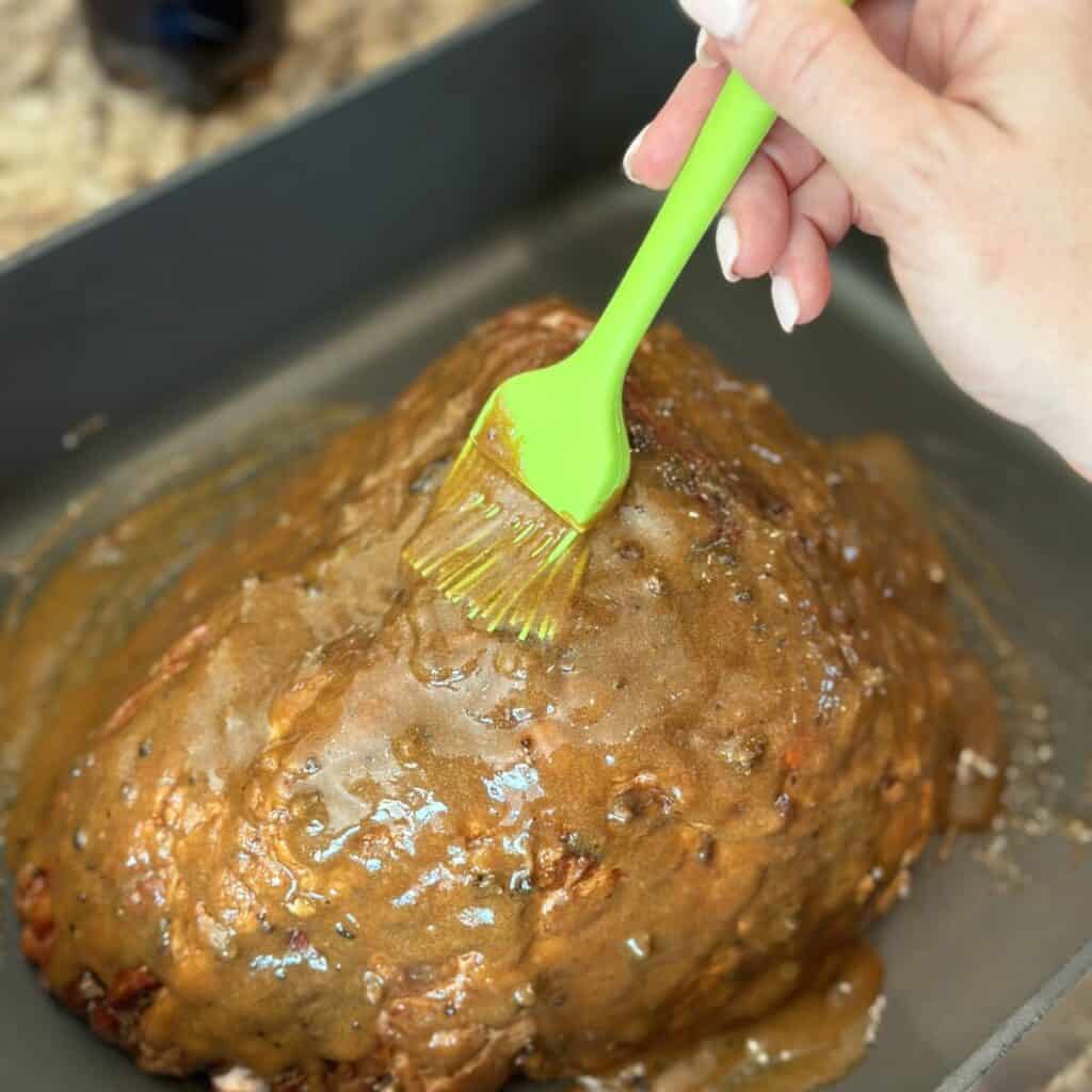 Brushing glaze on a ham.