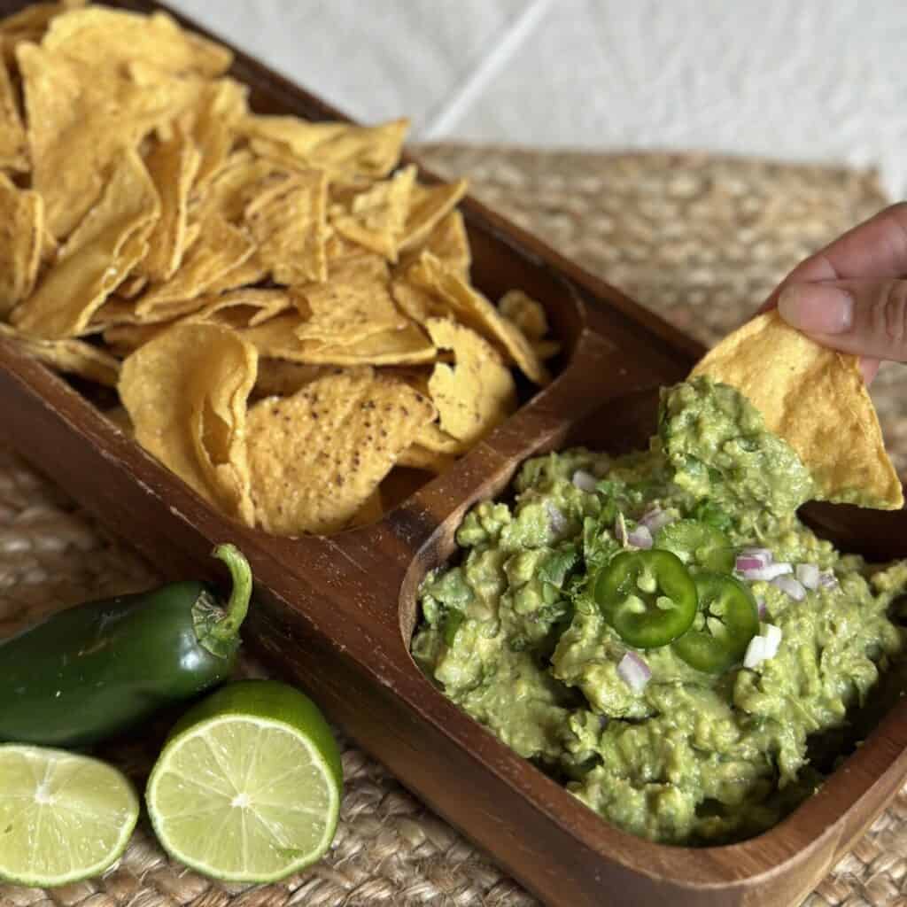 A chip going into guacamole.