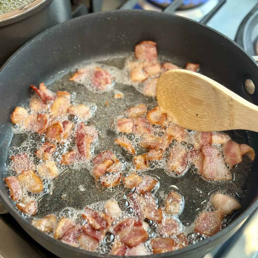 Cooking bacon in a skillet.