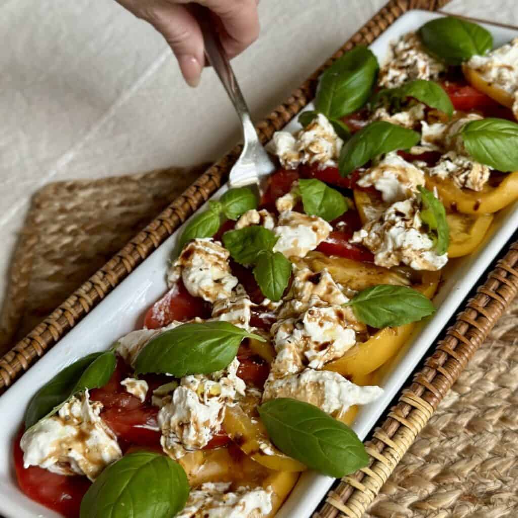 Getting a forkful of burrata caprese.