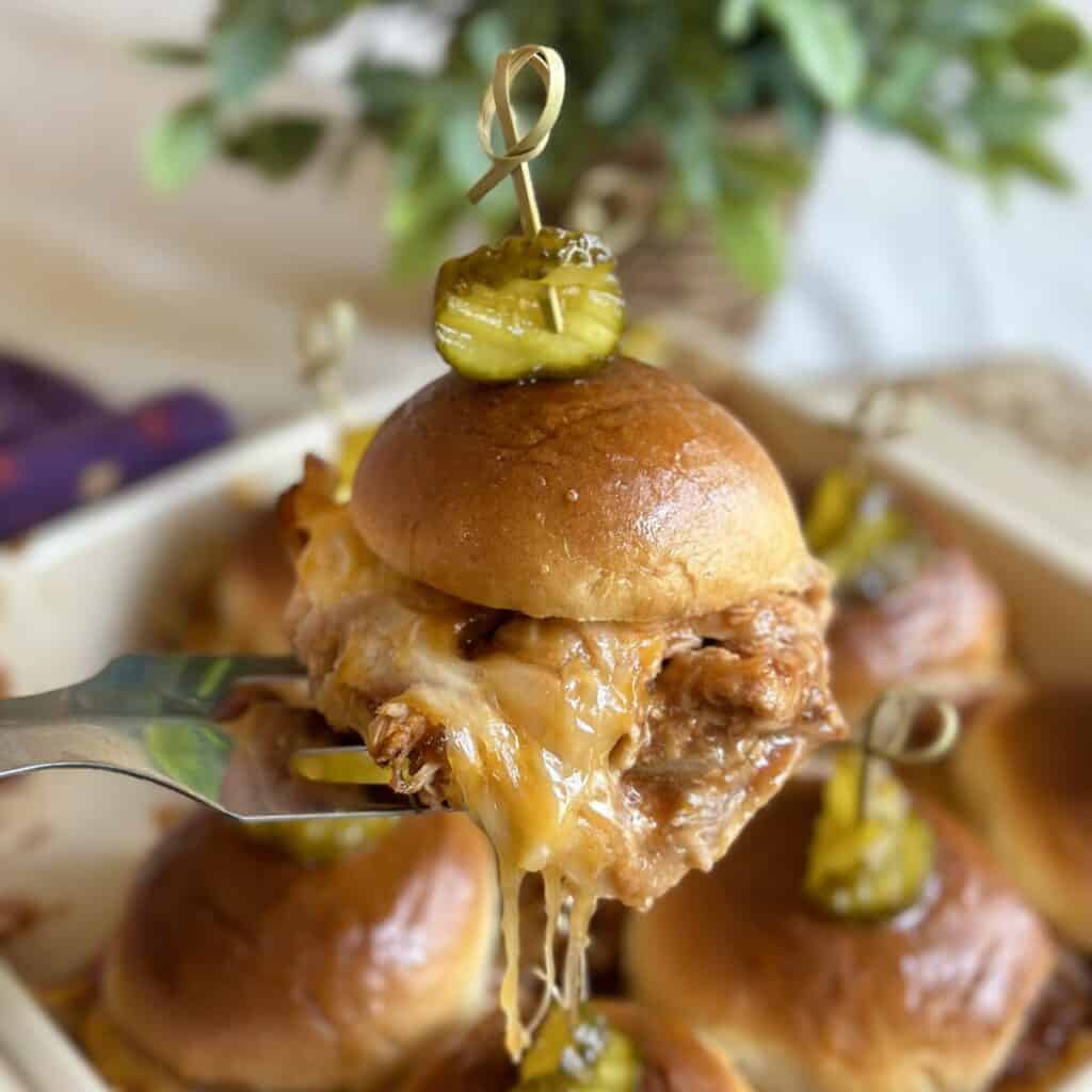 A barbecue chicken slider on a spatula