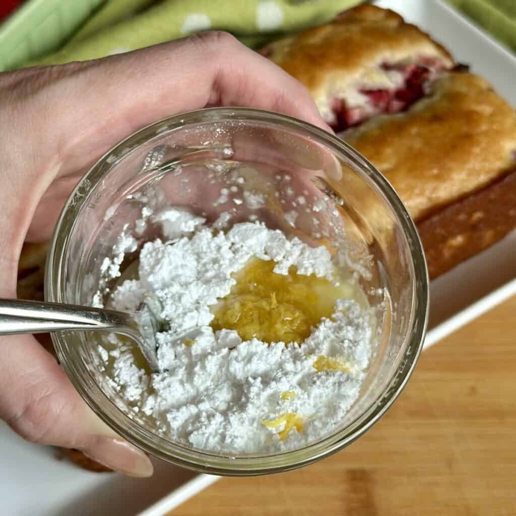 The ingredients in a bowl for glaze for a pound cake.