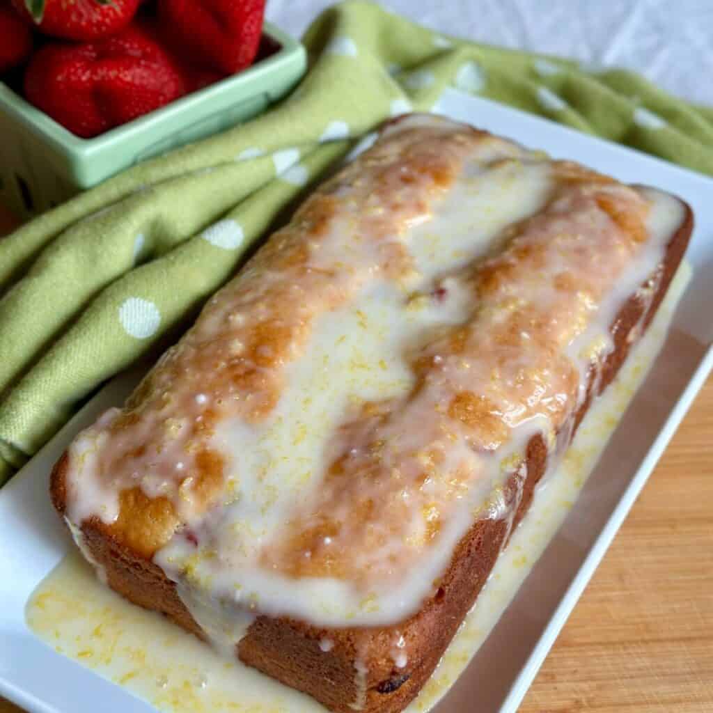 A pound cake with icing on top.