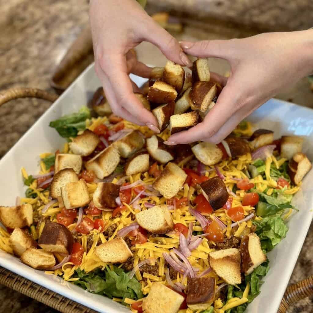 Adding croutons to a salad.