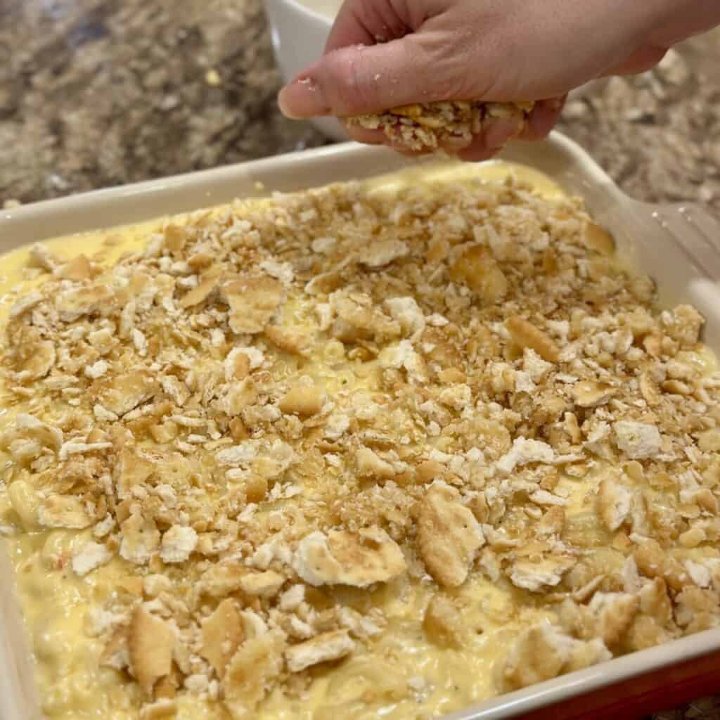 Adding buttery cracker crumbs to the top of pimento Mac and cheese.