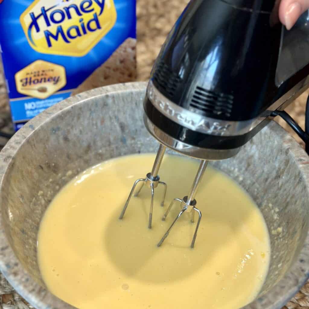 Mixing together pudding and milk.