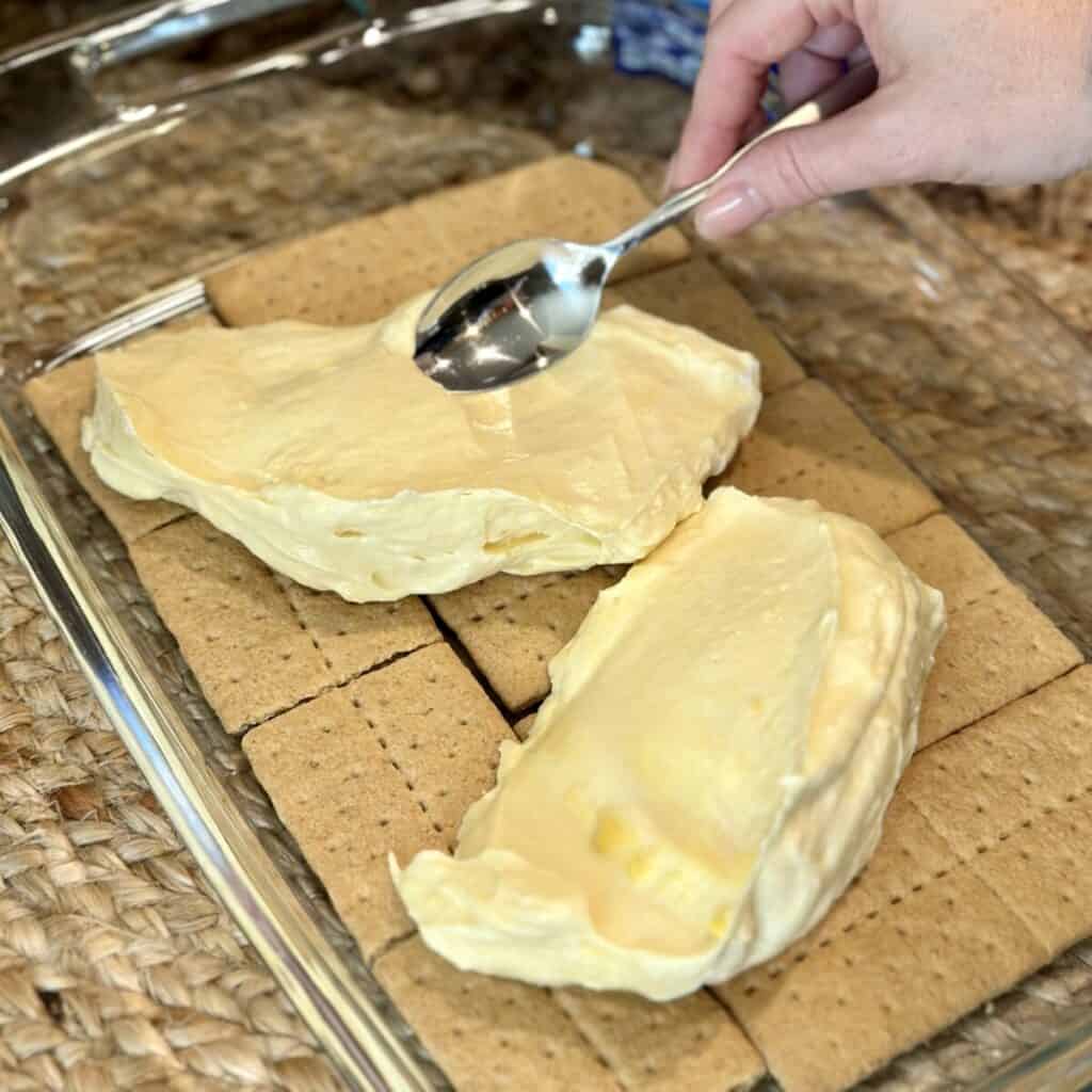 Spreading pudding on graham crackers.