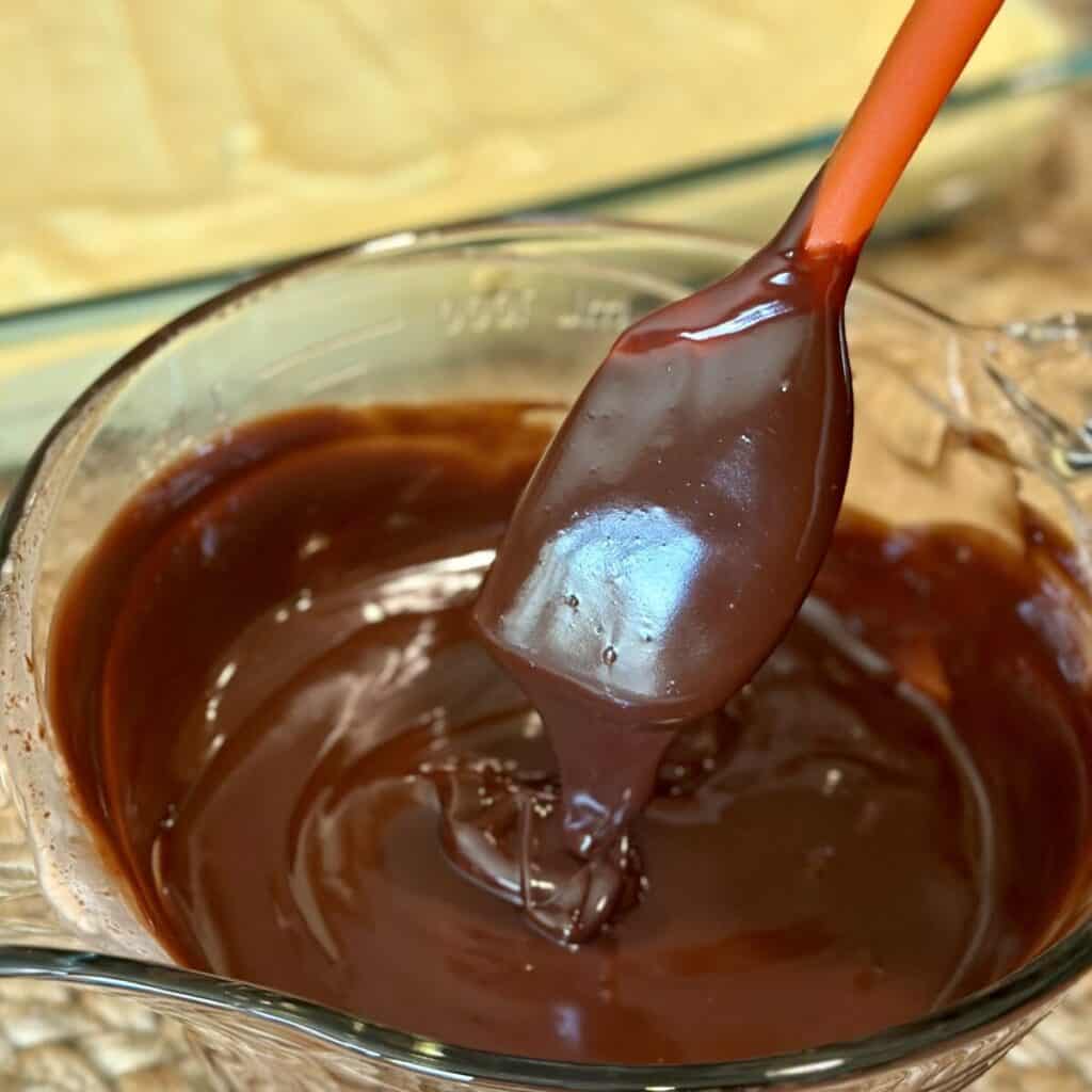 Mixing together chocolate ganache in a bowl.