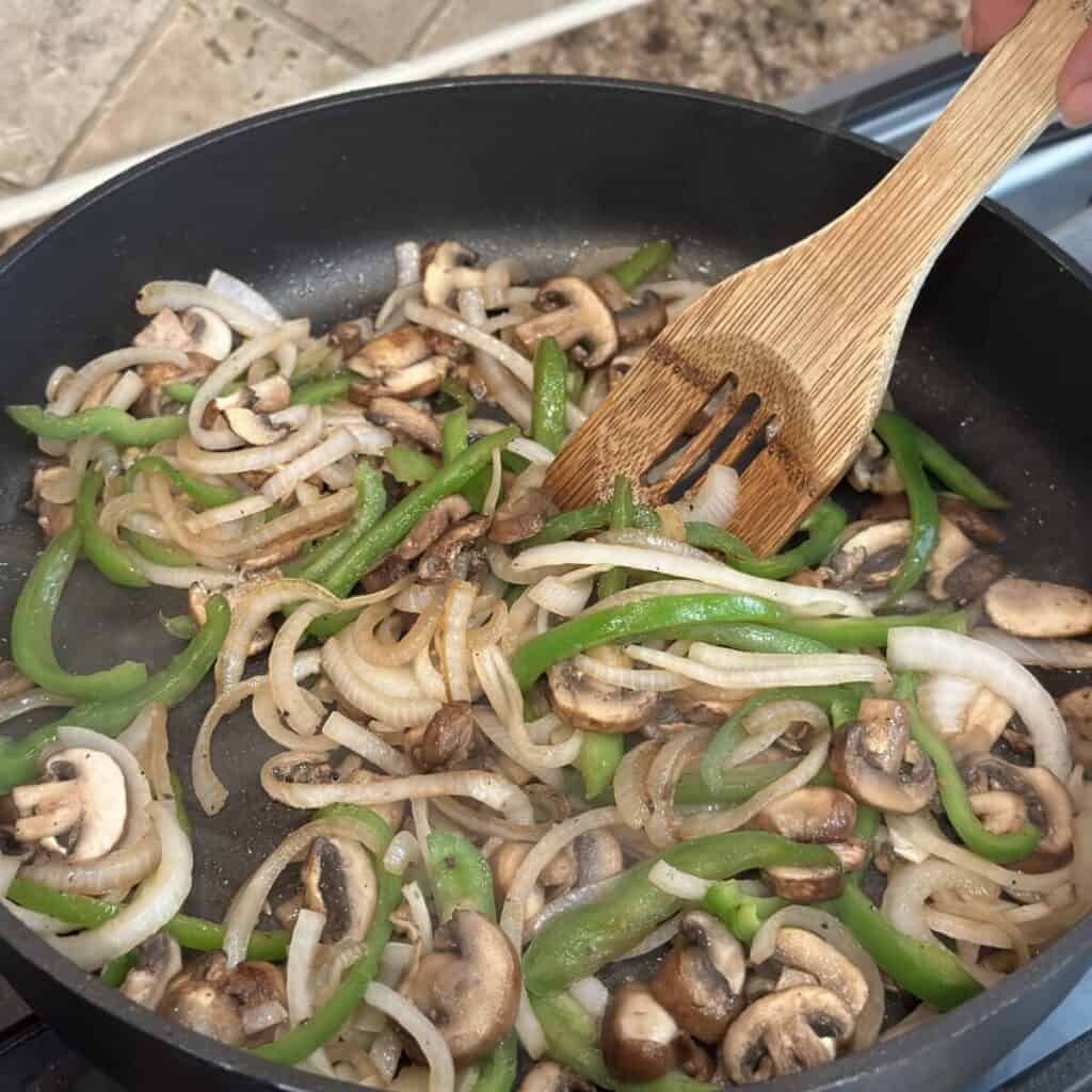 Sautéing veggies in a skillet.