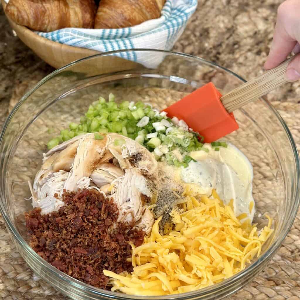 The ingredients to make chicken salad in a bowl.