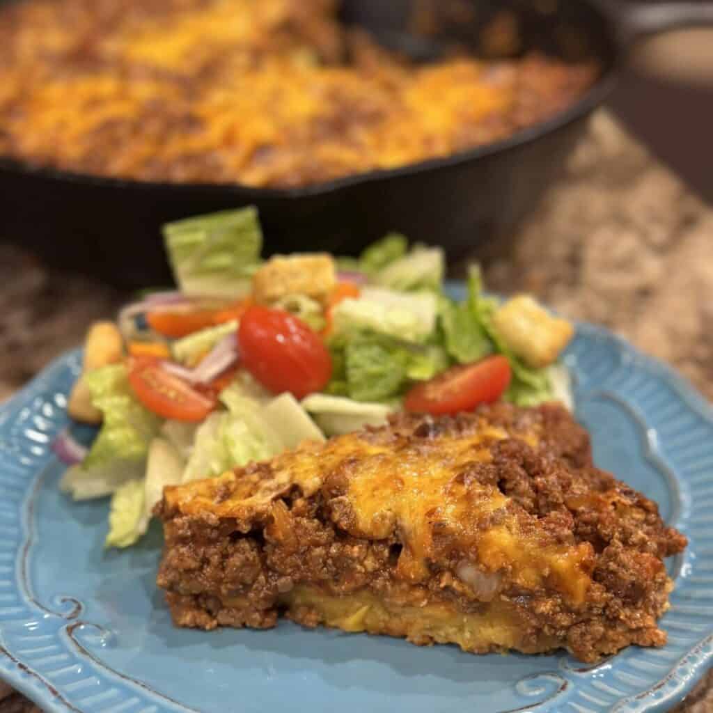 A slice of sloppy Joe cornbread casserole on a plate.