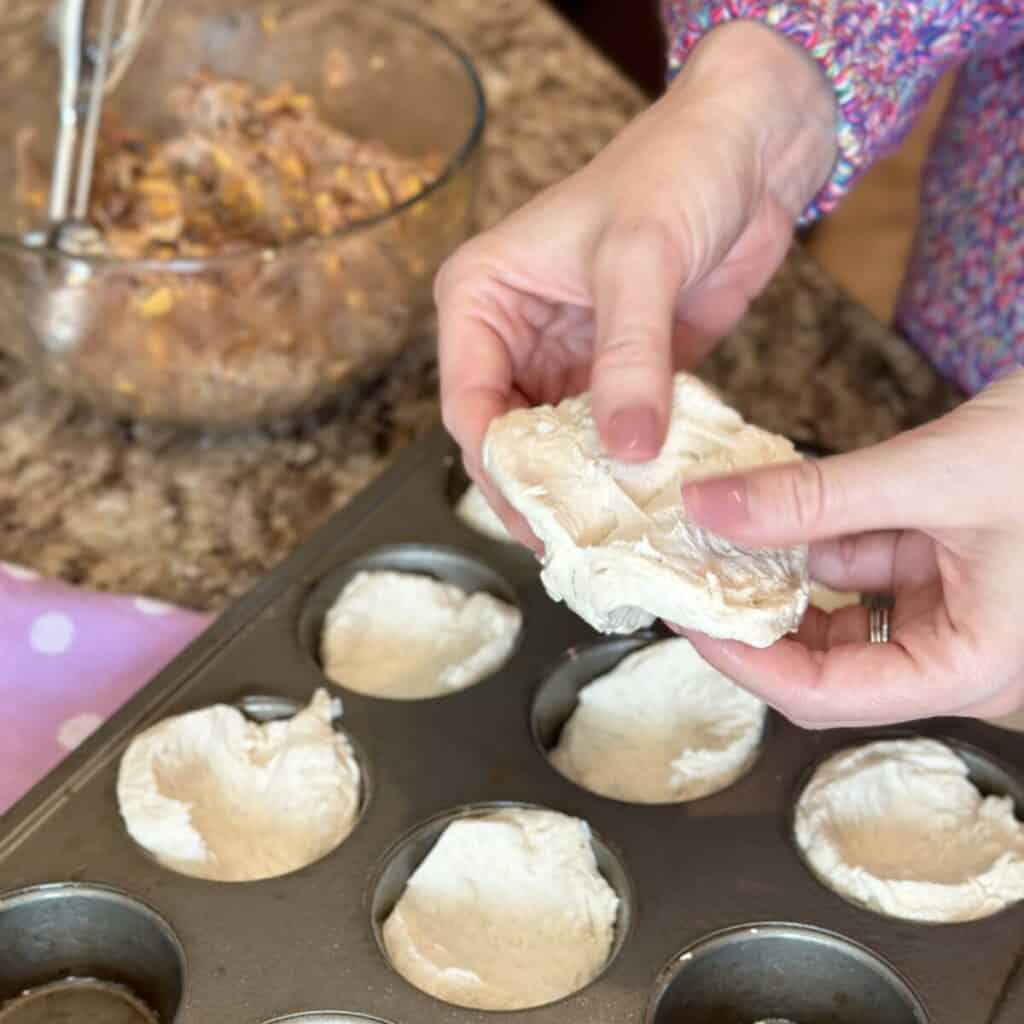 Peeling apart biscuit dough.