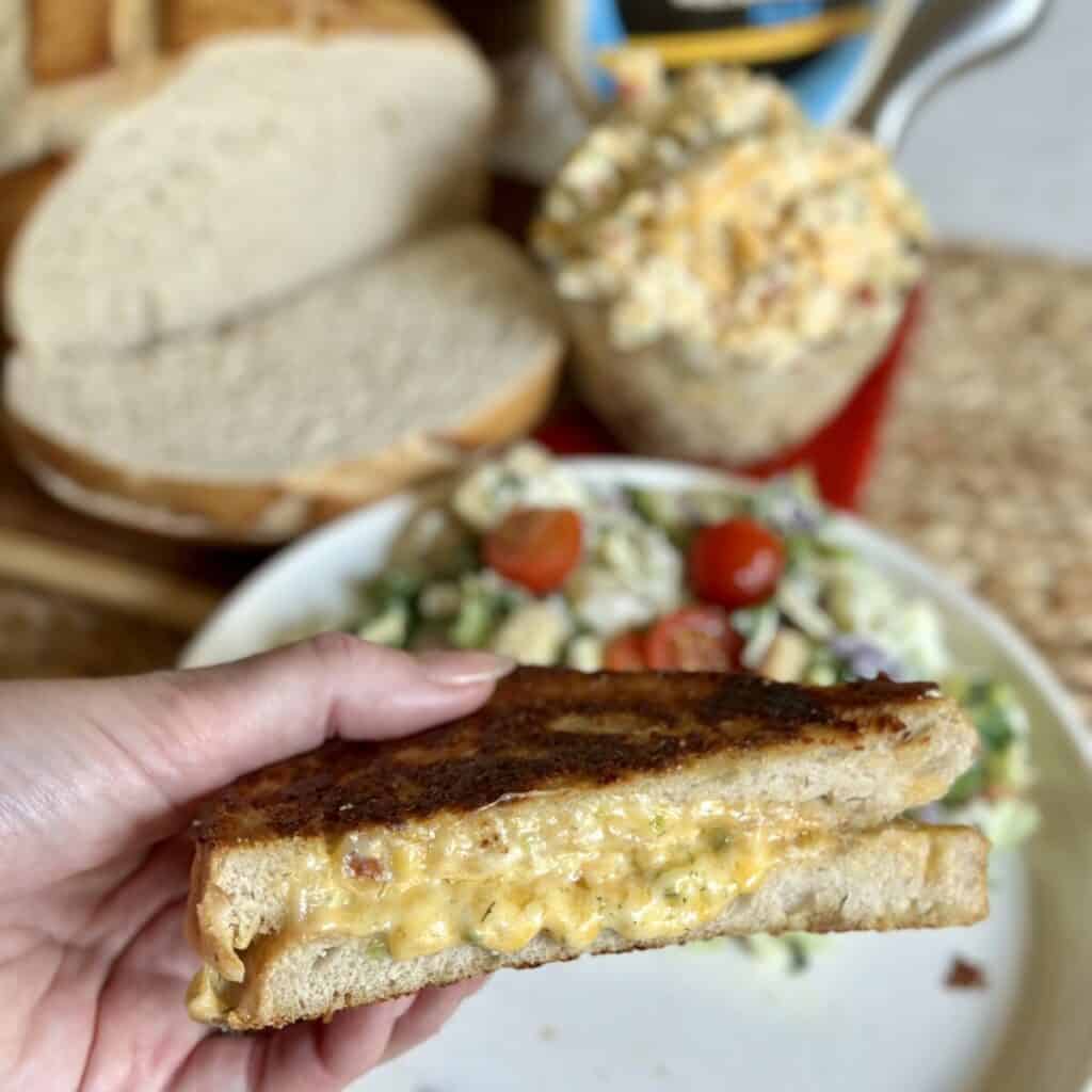 Holding a pimento grilled cheese.