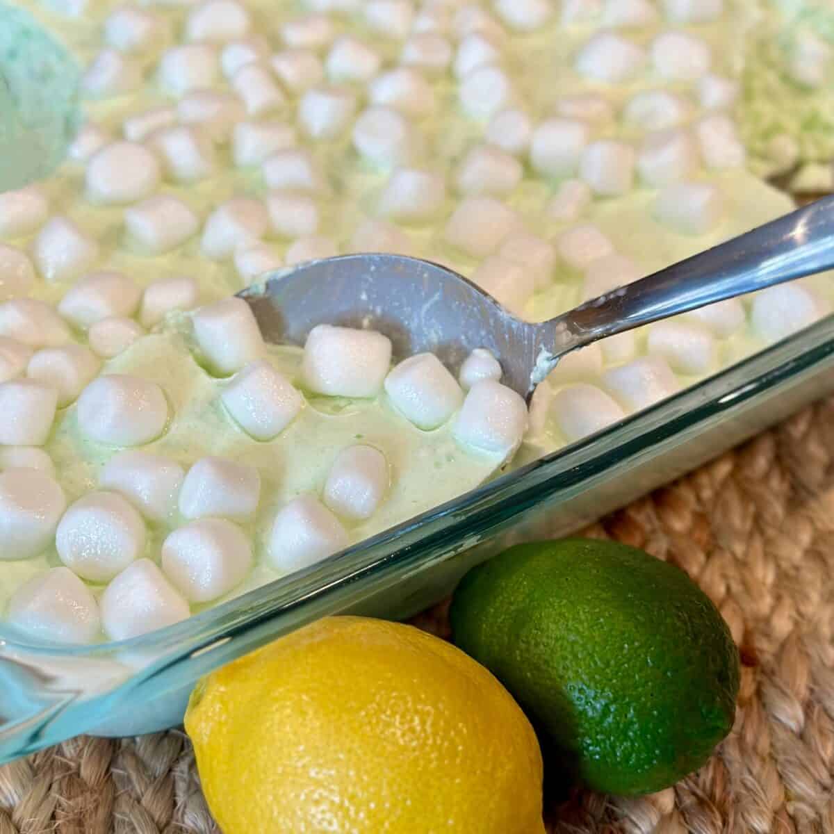 Getting a spoonful of green jello salad.