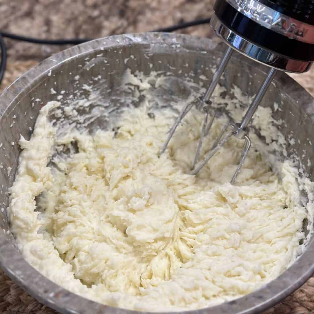 Whipping mashed potatoes with a mixer.