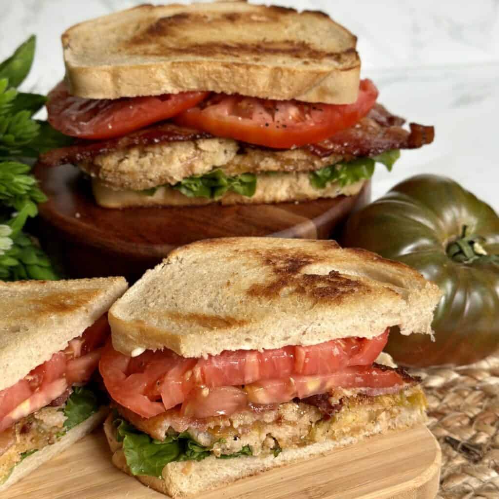 A sliced sandwich with BLT on top.