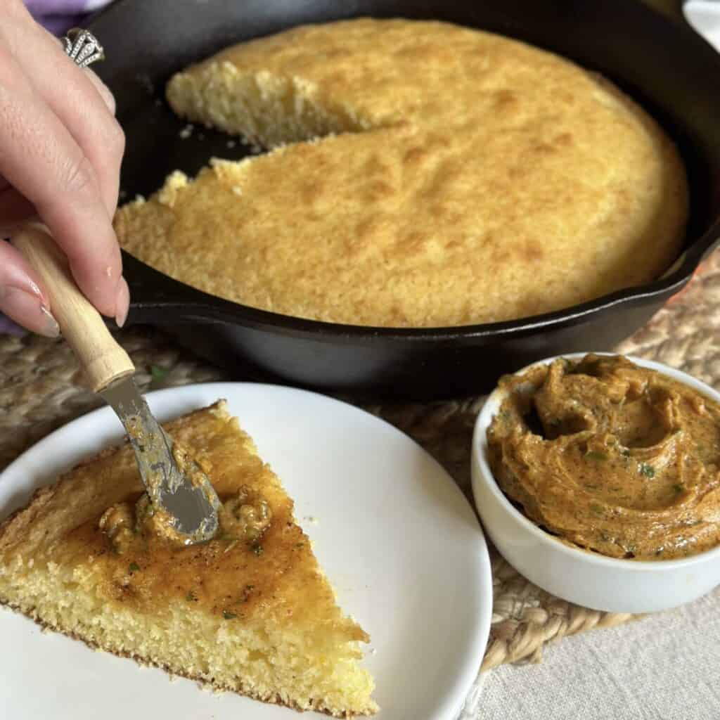 Spreading cajun butter on cornbread.