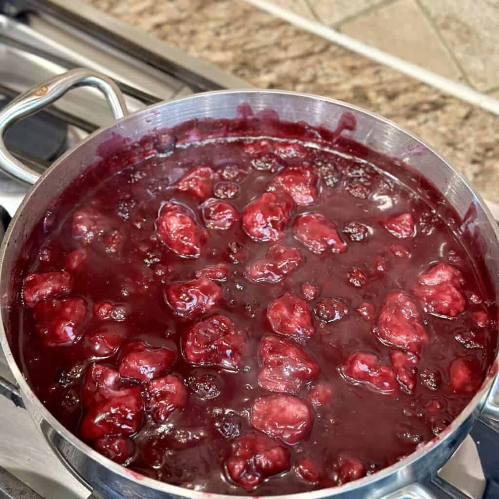 Blackberry dumplings in a skillet.