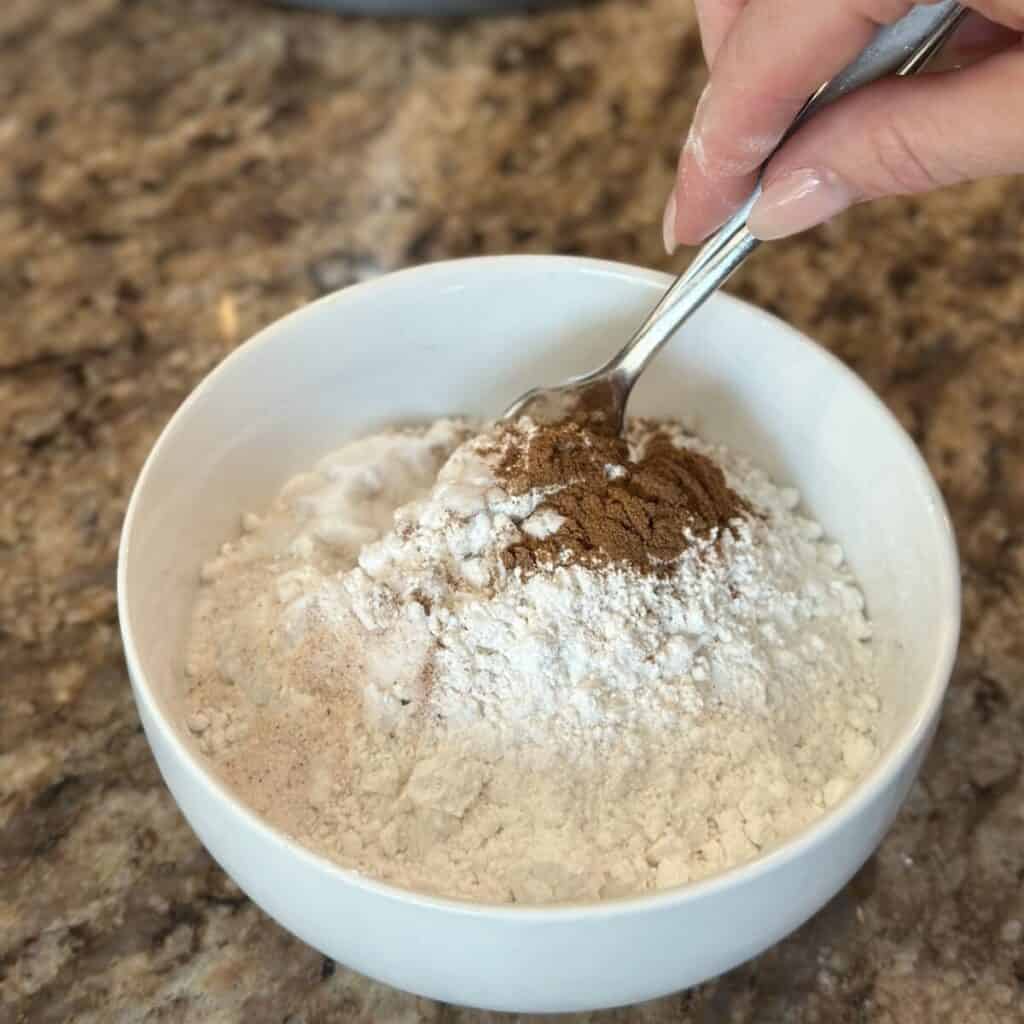 Mixing together dry ingredients for oatmeal cake.