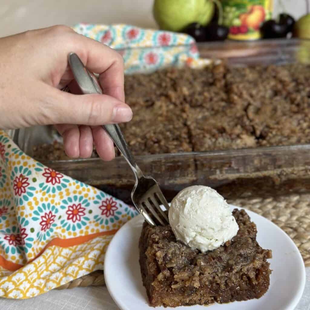 Getting a forkful of fruit cocktail cake.