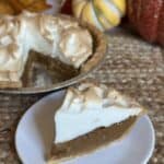 A slice of butterscotch meringue pie on a saucer.