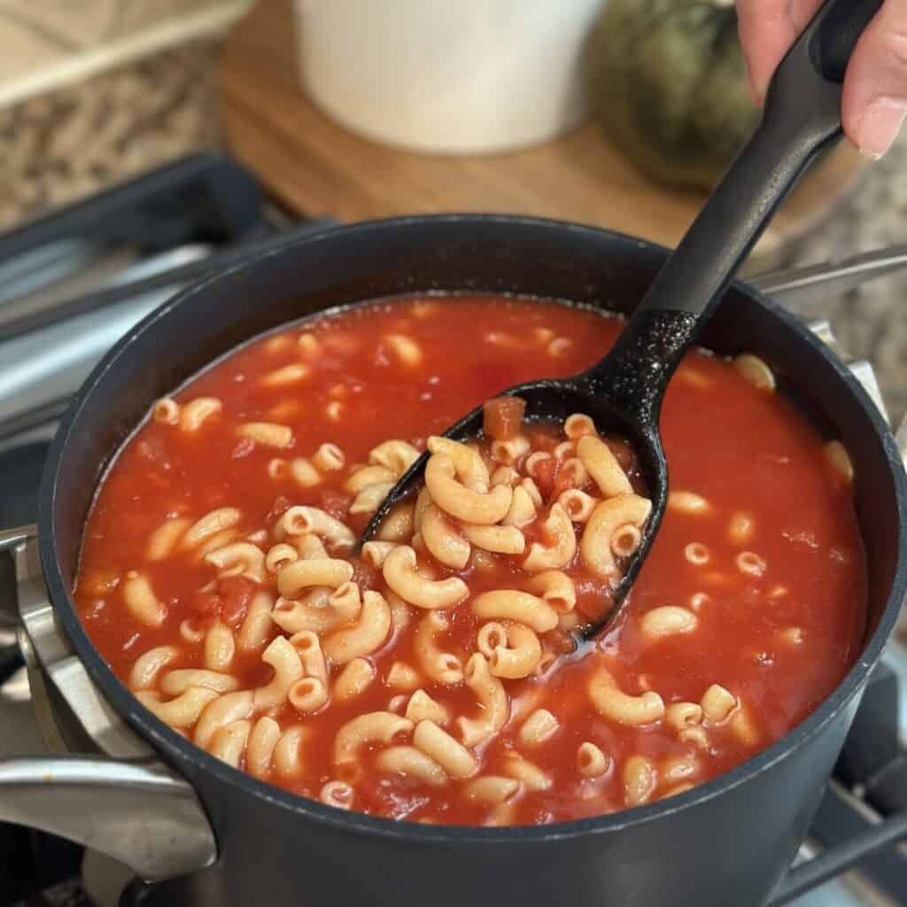 A pot of macaroni and tomatoes.