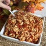 A bowl of macaroni and tomatoes.