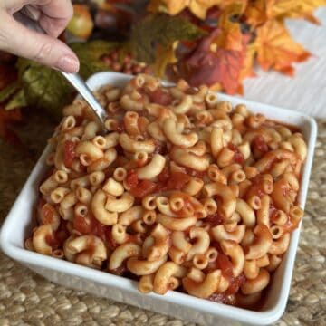 A bowl of macaroni and tomatoes.