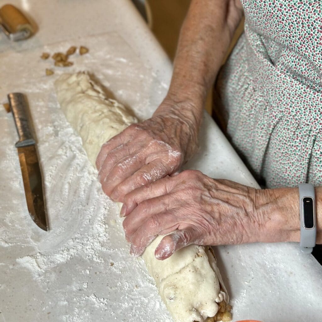 Rolling up an apple roll.