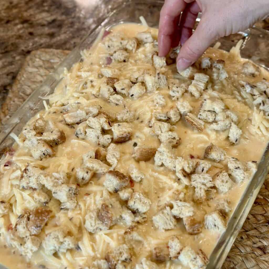 Adding crumbs to top of a casserole.