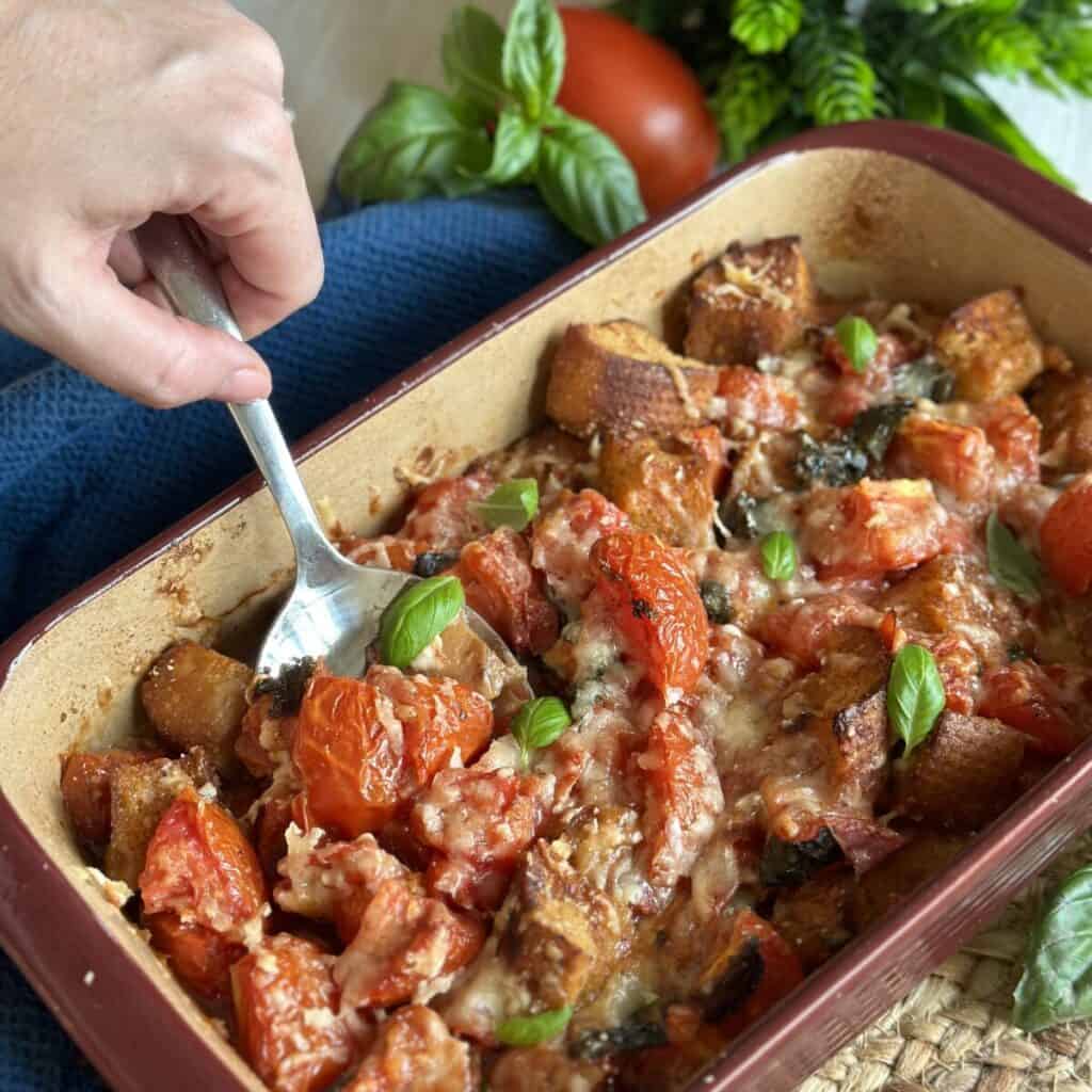 Getting a spoonful of scalloped tomatoes.