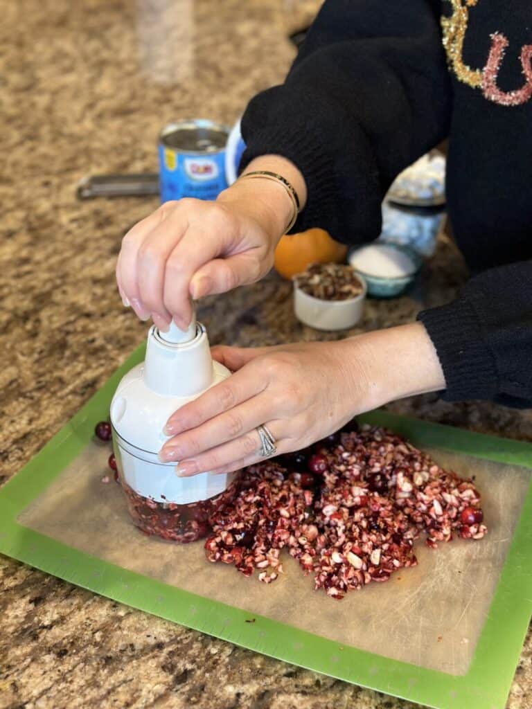 Chopping cranberries.