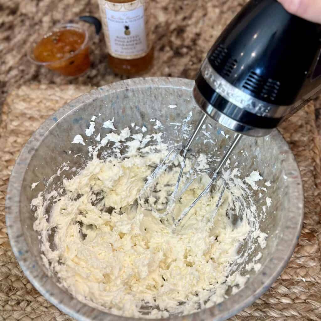 Whipping cream cheese in a bowl.