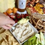 A bowl of pineapple cream cheese dip with dippers.