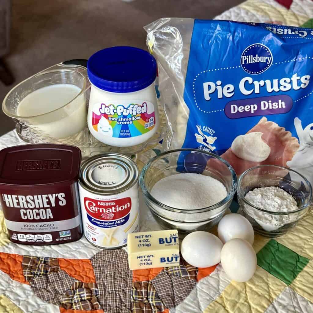 The ingredients to make a chocolate meringue pie.